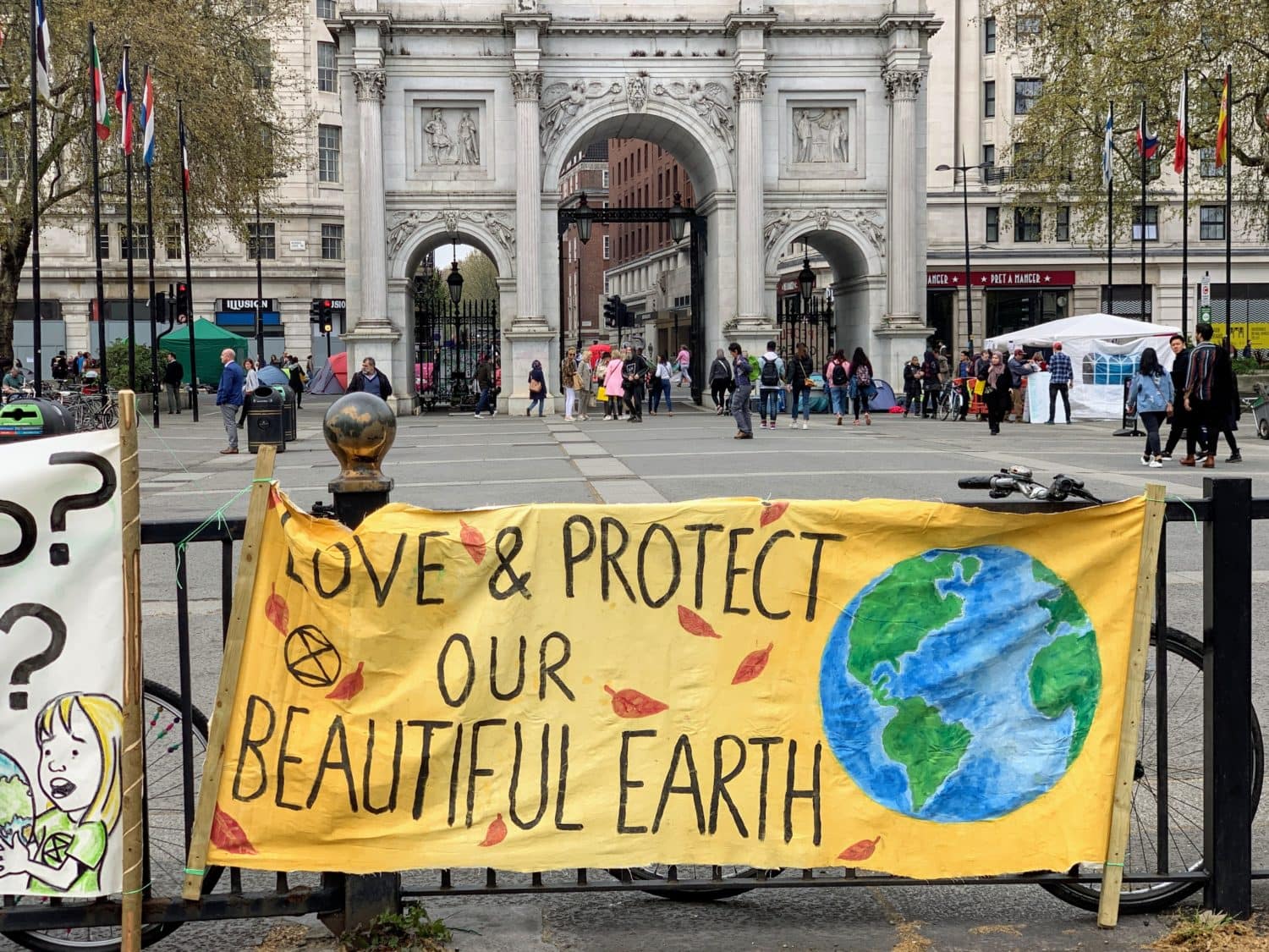 Banner saying Love and Protect our beautiful earth in front of Marble Arch